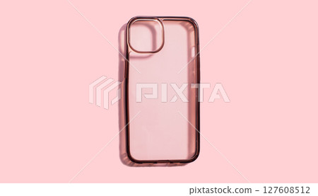 Transparent phone case on pink background, highlighting its old and dirty surface and dark sides. Usage of protection device for long time 127608512
