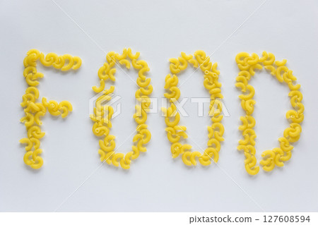 Word food. Italian food concept and menu design. Uncooked pasta on white background. Flat lay. Top view. Word food. Italian food concept and menu design. Uncooked pasta on white background. Flat lay. Top view. 127608594