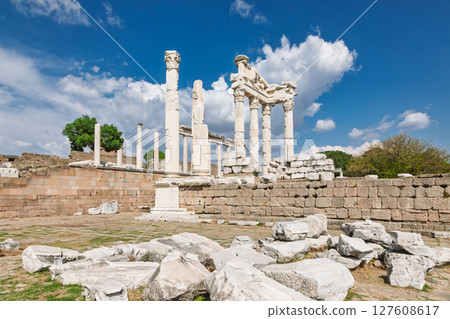 Wide view of Temple of Trajan ruins on Pergamon acropolis with standing marble columns and dramatic spring sky in Turkey 127608617