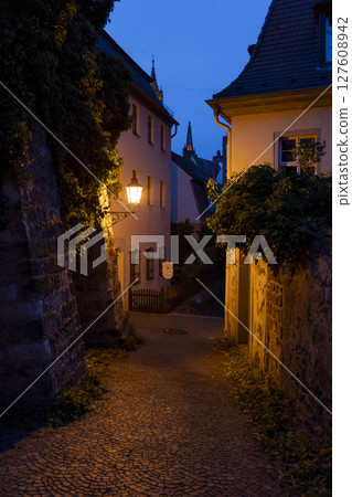 Discover the Charming Evening Ambiance and Delightful Atmosphere in a Quaint Alleyway 127608942