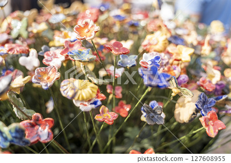 Vibrant, Colorful Ceramic Flowers in Bloom, Showcasing Exquisite Artisan Craftsmanship and Beauty Vibrant, Colorful Ceramic Flowers in Bloom, Showcasing Exquisite Artisan Craftsmanship and Beauty 127608955