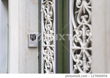 An Intricate Doorway Design that Features a Modern Intercom System for Enhanced Communication An Intricate Doorway Design that Features a Modern Intercom System for Enhanced Communication 127608956