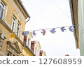 Charming and Enchanting Street adorned with Colorful Decorative Bunting and Urban Architecture 127608959
