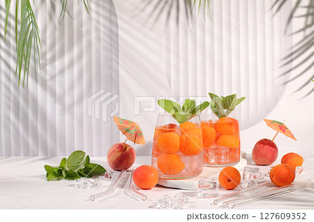Refreshing summer drink recipe. Cold homemade lemonade, juice or cocktail with mint, apricots, peaches and citrus fruits, detox diet and weight loss concept, restaurant menu, selective approach. 127609352