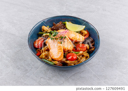 Grilled Salmon Rice Noodles with Roasted Vegetables and Lime Wedge Grilled Salmon Rice Noodles with Roasted Vegetables and Lime Wedge 127609491
