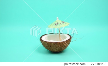 Half coconut shell on turquoise background 127610449