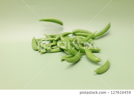 Snack peas on a green background 127610459