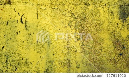 Weathered yellow painted wall close-up texture 127611020