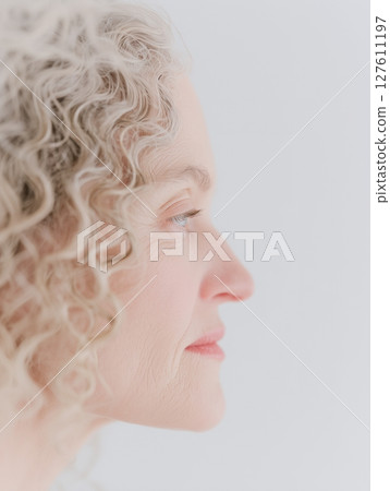 Senior woman profile close-up Simple portrait on white background 127611197