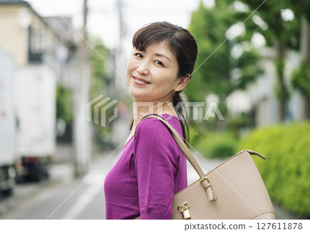 Outdoor portrait of a middle-aged woman in her 50s going to work 127611878