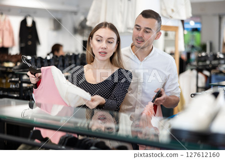 Couple young woman and young man choosing blouse 127612160