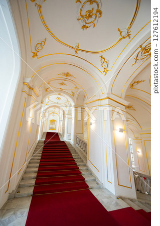 Internal staircase in palace, walls are decorated with gold-colored monograms in Bratislava castle Internal staircase in palace, walls are decorated with gold-colored monograms in Bratislava castle 127612194