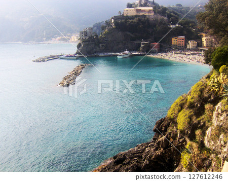 Majestic panoramic shot of the Cinque Terre coastline in Tuscany, Italy, showcasing the union of steep cliffs, vivid coastal villages, and the deep blue Ligurian Sea. Majestic panoramic shot of the Cinque Terre coastline in Tuscany, Italy, showcasing the union of steep cliffs, vivid coastal villages, and the deep blue Ligurian Sea. 127612246