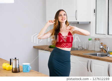 Portrait of attractive woman have fun dancing near table Portrait of attractive woman have fun dancing near table 127612289