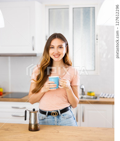 Portrait of attractive woman drinking coffee at home 127612296