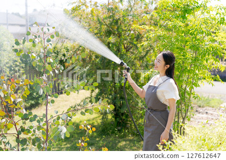 Woman watering the garden 127612647