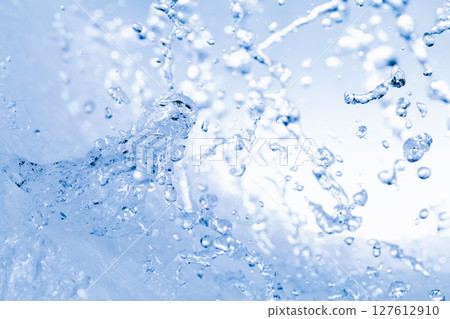 Water splashes on a blue background. Water splashes on a blue background. 127612910