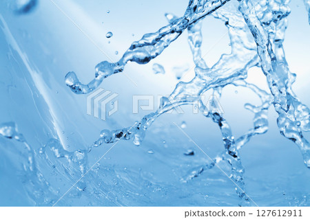Water splashes on a blue background. 127612911