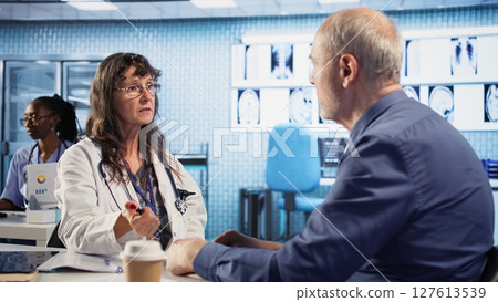 Professional medic examining patient reaction to light for pupil response during concussion assessment, checking for dizziness, light sensitivity and balance issues. Trauma checkup. Camera A. 127613539