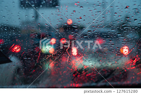 Rain drop on the car glass window while driving on the road. 127615280