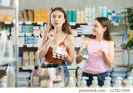 Mom and teen girl child buyer select face cosmetic pallet 127617894