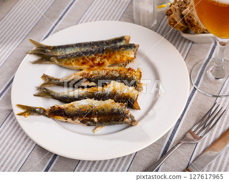 Fried sardine fish served on plate Fried sardine fish served on plate 127617965