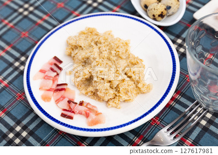 Oatmeal served with lard on plate Oatmeal served with lard on plate 127617981