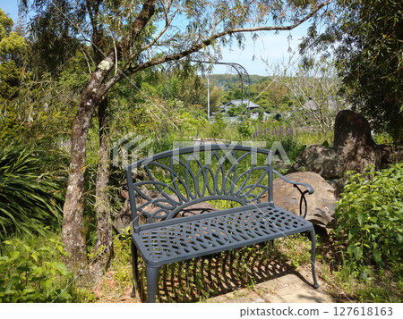 A landscape with a bench 127618163