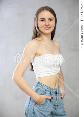 Young smiling woman posing in studio Young smiling woman posing in studio 127618202