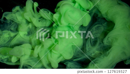 Smoke stream. Dye spread. Bright color green paint explosion flow. Art fume wave spray abstract blur black sparkling water background. 127619327