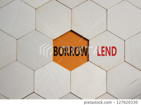 Lend or Borrow symbol. Concept word Lend or Borrow on wooden comb puzzle. Beautiful orange background. Business and Lend or Borrow concept. Copy space 127620330