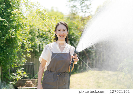 女人在花園裡澆水 女人在花園裡澆水 127621161