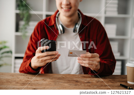 Man hands using smartphone and holding credit card sitting. Online Shopping payments  concept. 127621327