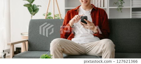 Man hands using smartphone and holding credit card sitting. Online Shopping payments concept. Man hands using smartphone and holding credit card sitting. Online Shopping payments concept. 127621366
