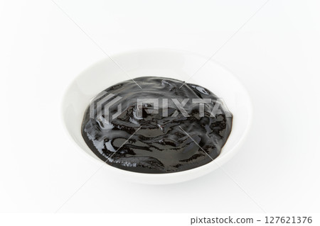 Sweet bean sauce in a small dish on a white background 127621376
