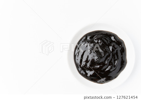 Sweet bean sauce in a small dish on a white background 127621454
