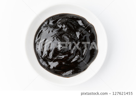 Sweet bean sauce in a small dish on a white background 127621455