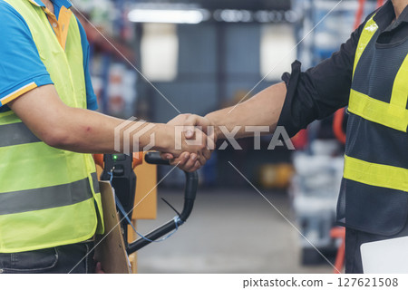 Close up warehouse worker shakehand together. Engineer man hands partnership. Diversity Coworker Men logistics Warehouse teams handshake. Multiracial Support team greeting person teamwork colleagues Close up warehouse worker shakehand together. Engineer man hands partnership. Diversity Coworker Men logistics Warehouse teams handshake. Multiracial Support team greeting person teamwork colleagues 127621508