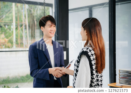 Business partnership handshake concept.Photo two coworkers handshaking process.Successful deal after great meeting. Business partnership handshake concept.Photo two coworkers handshaking process.Successful deal after great meeting. 127621573
