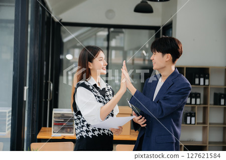 Business partnership handshake concept.Photo two coworkers handshaking process.Successful deal after great meeting. Business partnership handshake concept.Photo two coworkers handshaking process.Successful deal after great meeting. 127621584