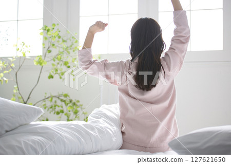 Young woman relaxing in pajamas Young woman relaxing in pajamas 127621650