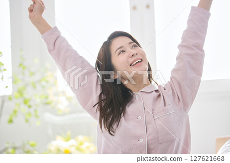 Young woman relaxing in pajamas Young woman relaxing in pajamas 127621668