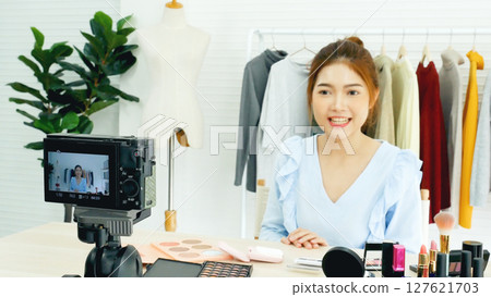 Beauty blogger video production for female fashion blog online cosmetic adviser record woman lifestyle tutorial. Trendy female vlogger showing how to use cosmetics products live via social media. 127621703