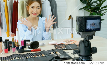 Beauty blogger video production for female fashion blog online cosmetic adviser record woman lifestyle tutorial. Trendy female vlogger showing how to use cosmetics products live via social media. 127621704