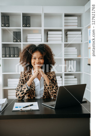 Successful African Businesswoman Analyzing Finance on Tablet and Laptop at modern Office Desk tax, Successful African Businesswoman Analyzing Finance on Tablet and Laptop at modern Office Desk tax, 127621768
