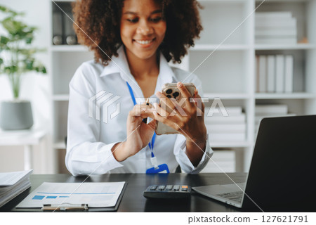 Successful African Businesswoman Analyzing Finance on Tablet and Laptop at modern Office Desk tax, Successful African Businesswoman Analyzing Finance on Tablet and Laptop at modern Office Desk tax, 127621791