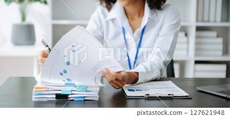 Successful African Successful African Businesswoman Analyzing Finance on Tablet and Laptop at modern Office Desk tax, Analyzing Finance on Tablet and Laptop at modern Office Desk tax, 127621948