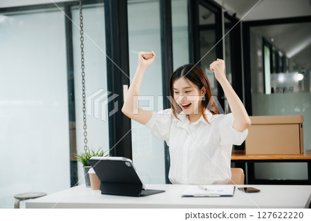 business woman are delighted and happy with the work they do on their tablet, laptop and taking notes at the office. business woman are delighted and happy with the work they do on their tablet, laptop and taking notes at the office. 127622220