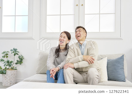 Senior couple smiling portrait living room 127622341