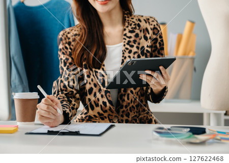 Young woman running online store Startup small business SME, using smartphone or tablet receive and checking online purchase shopping order 127622468